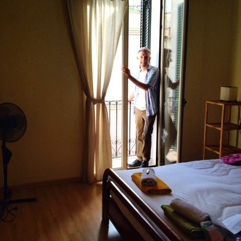 Mike in the main bedroom, with its balcony overlooking the street.